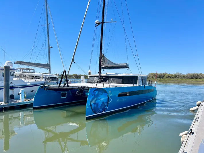 Silver Chain Yacht Photos Pics 2024 Balance 442 catamaran docked in calm marina waters under clear blue sky.