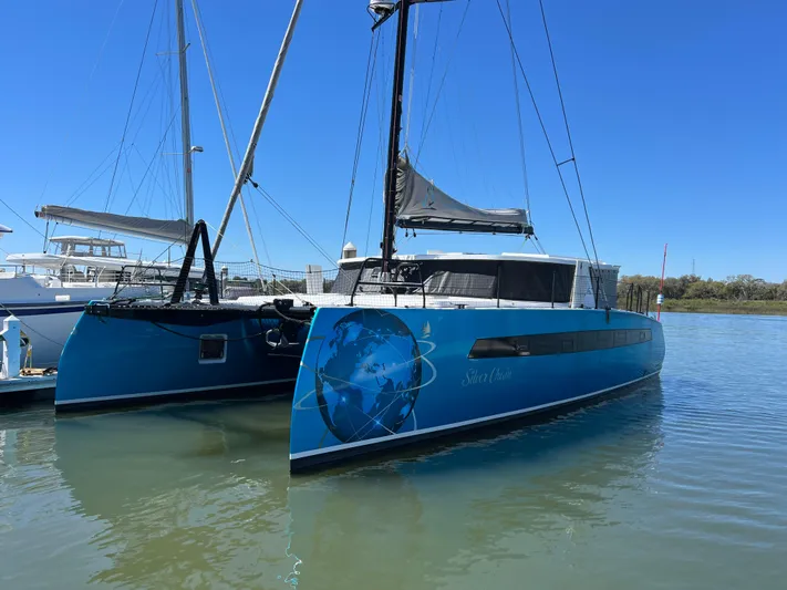 Silver Chain Yacht Photos Pics 2024 Balance 442 catamaran docked, featuring a blue hull with a globe design.