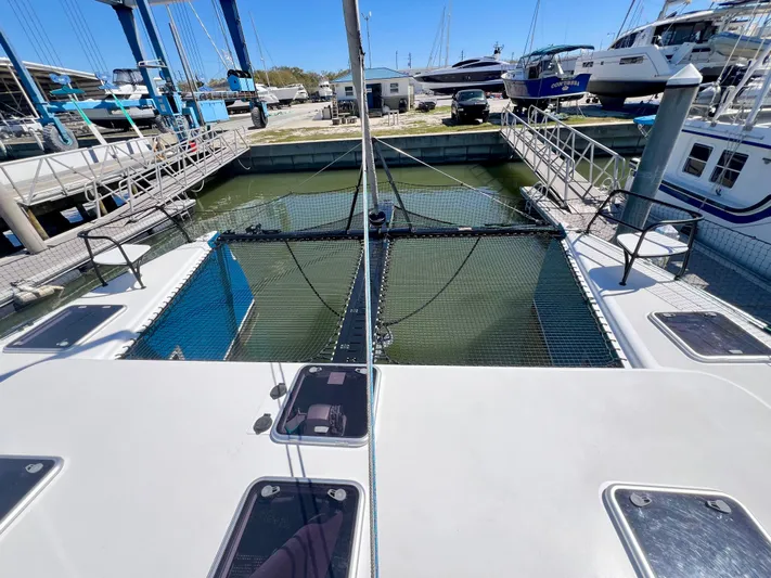 Silver Chain Yacht Photos Pics 2024 Balance 442 catamaran docked at a marina, showcasing deck and netting.