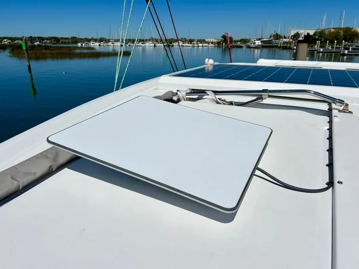 Silver Chain Yacht Photos Pics Rooftop solar panel on 2024 Balance 442 boat, docked by calm waters.