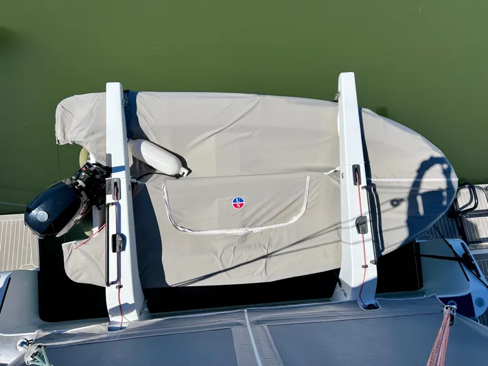 Silver Chain Yacht Photos Pics Aerial view of a covered Balance 442 boat, 2024 model, docked on green water.