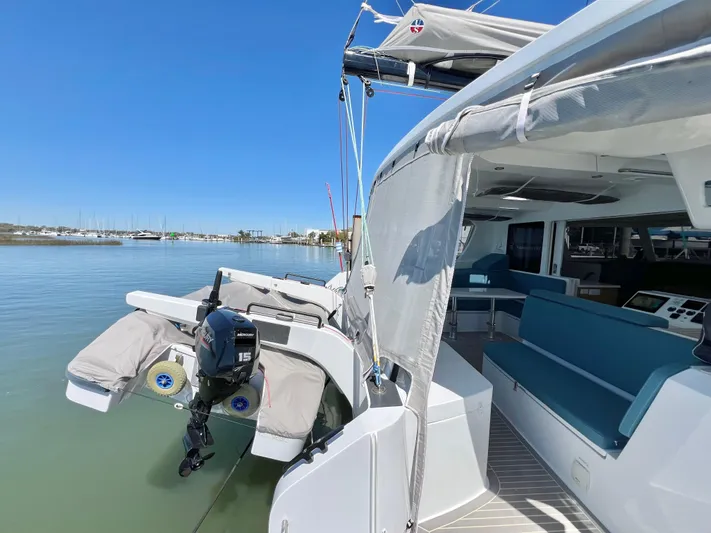 Silver Chain Yacht Photos Pics 2024 Balance 442 yacht with outboard motor, docked in a serene marina setting.