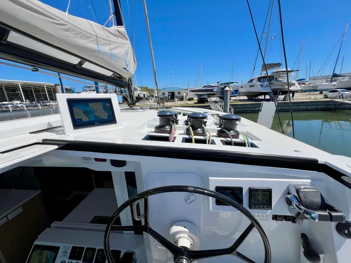 Silver Chain Yacht Photos Pics Sailboat cockpit of 2024 Balance 442 with navigation equipment and steering wheel in marina.