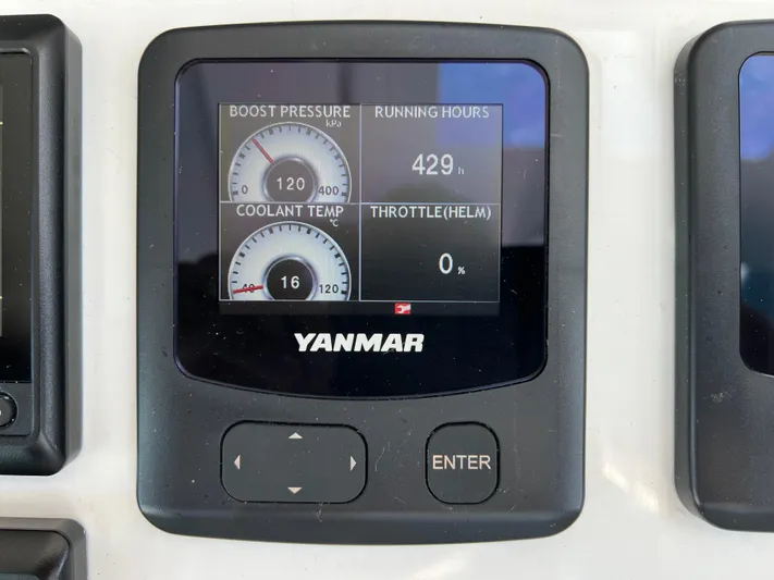 Silver Chain Yacht Photos Pics Digital display showing engine metrics: boost pressure, coolant temperature, running hours, and throttle percentage.
