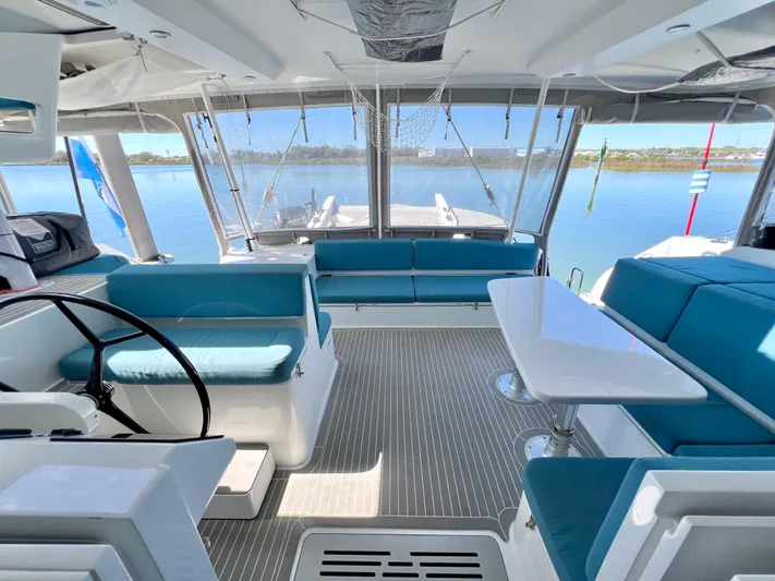 Silver Chain Yacht Photos Pics Luxurious 2024 Balance 442 yacht interior with blue seating and panoramic windows.