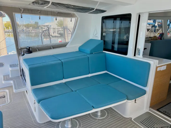 Silver Chain Yacht Photos Pics Modern 2024 Balance 442 yacht interior with blue cushioned seating and marina view.