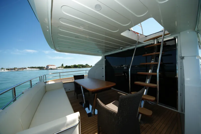  Yacht Photos Pics Luxurious VZ 68 yacht deck with seating, table, and stairs, 2009 model.