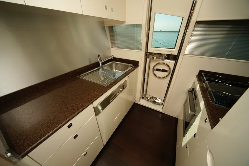  Yacht Photos Pics Modern yacht kitchen interior with sleek countertops, stainless steel sink, and ocean view window. VZ 68, 2009.