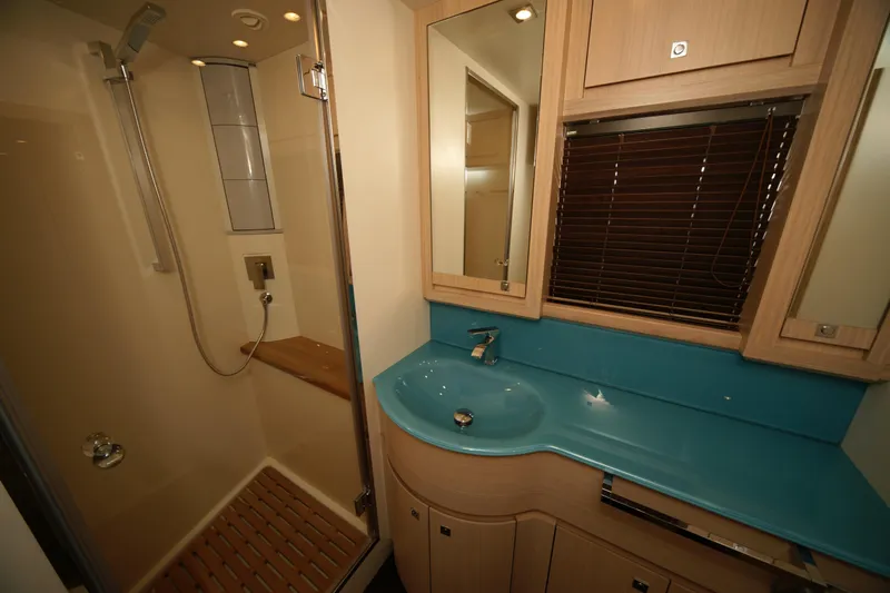  Yacht Photos Pics Modern bathroom in 2009 VZ 68 yacht with shower, blue countertop, and wooden cabinets.