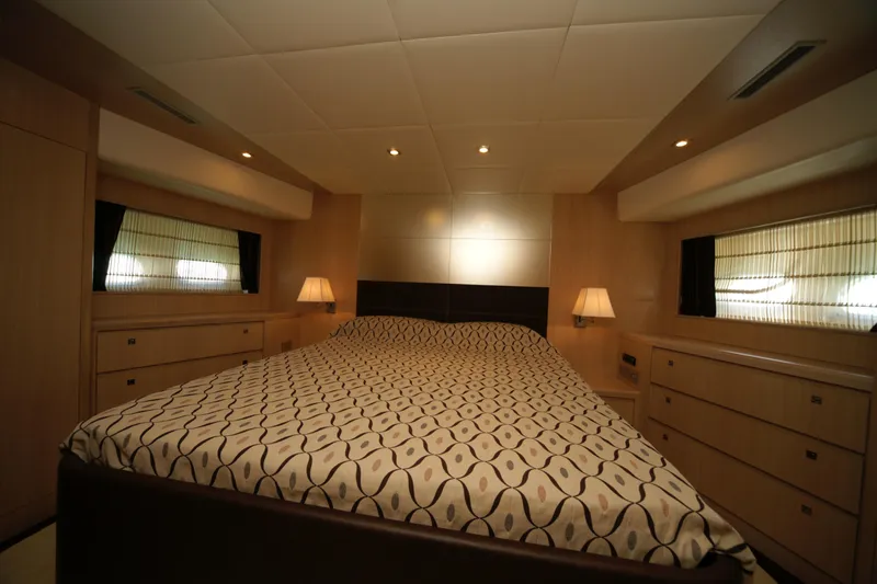  Yacht Photos Pics Luxurious bedroom interior on a 2009 VZ 68 yacht with elegant bedding and ambient lighting.
