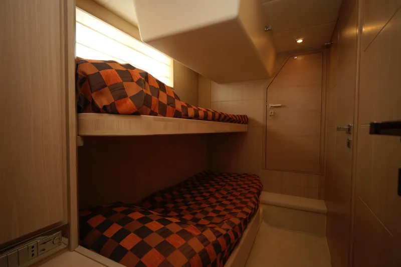  Yacht Photos Pics Compact cabin with bunk beds and checkered bedding in a 2009 VZ 68 model.