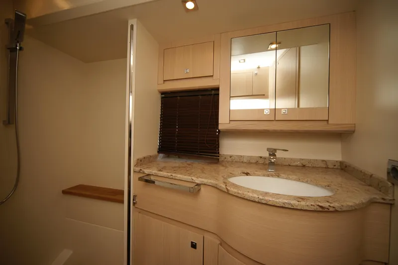  Yacht Photos Pics Luxurious bathroom in 2009 VZ 68 yacht with modern fixtures and elegant wood cabinetry.