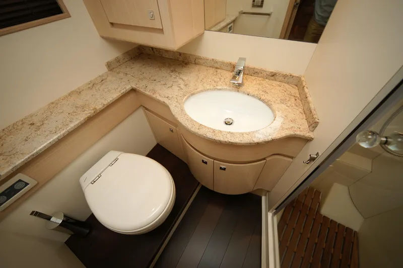  Yacht Photos Pics Luxurious yacht bathroom with marble countertop, modern sink, and toilet in a 2009 VZ 68 model.