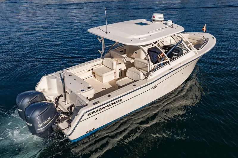  Yacht Photos Pics 2018 Grady-White Freedom 307 boat cruising on open water, featuring dual Yamaha engines.