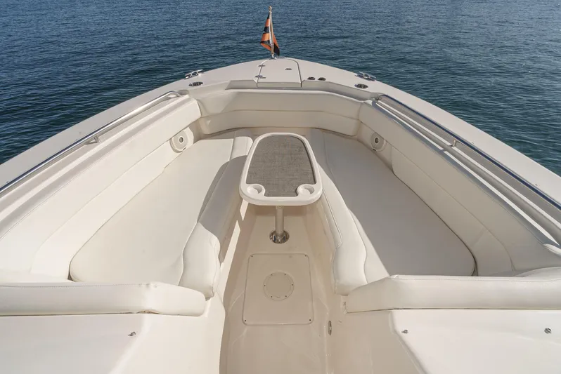  Yacht Photos Pics 2018 Grady-White Freedom 307 boat interior with seating and table on calm water.