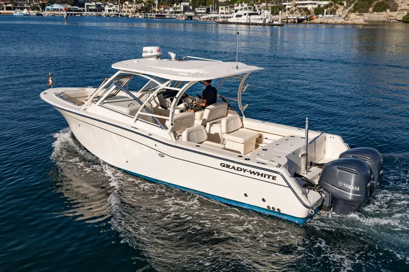  Yacht Photos Pics 2018 Grady-White Freedom 307 boat cruising on a calm blue sea.