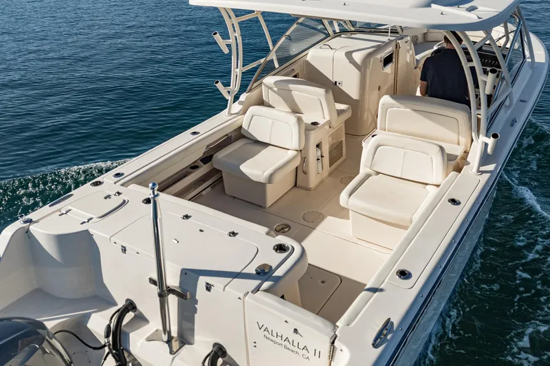  Yacht Photos Pics 2018 Grady-White Freedom 307 boat on water, featuring spacious seating and sleek design.