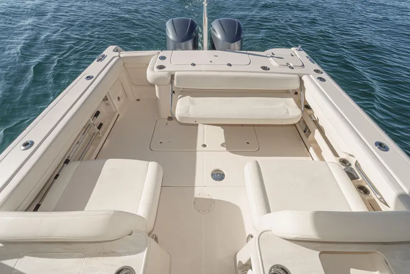  Yacht Photos Pics 2018 Grady-White Freedom 307 boat deck with seating, on calm water.