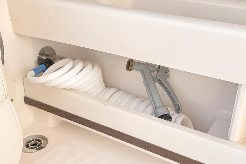  Yacht Photos Pics Coiled hose and spray nozzle in Grady-White Freedom 307 boat compartment, 2018 model.