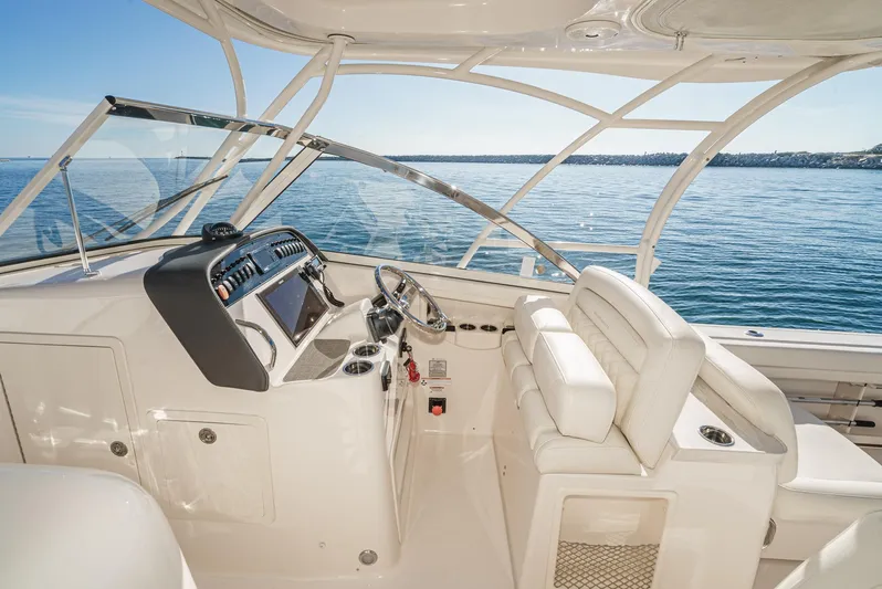  Yacht Photos Pics 2018 Grady-White Freedom 307 boat interior with helm, overlooking calm blue waters.