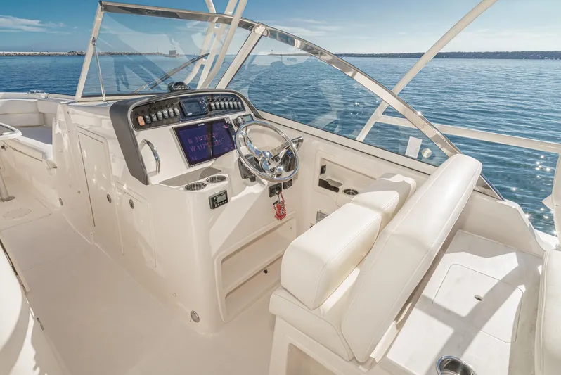  Yacht Photos Pics 2018 Grady-White Freedom 307 boat interior with steering wheel and navigation system.