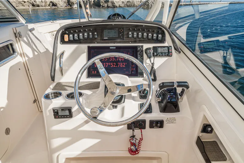  Yacht Photos Pics 2018 Grady-White Freedom 307 boat dashboard with steering wheel and navigation controls.