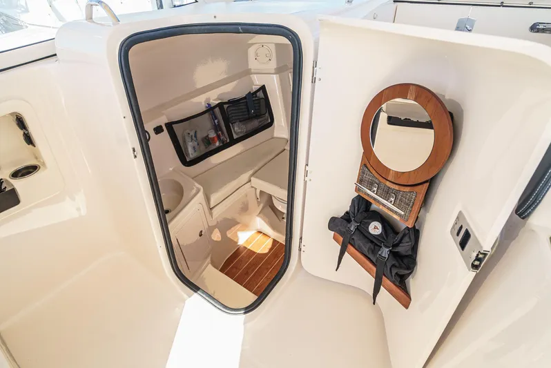  Yacht Photos Pics 2018 Grady-White Freedom 307 boat interior with compact cabin and amenities.
