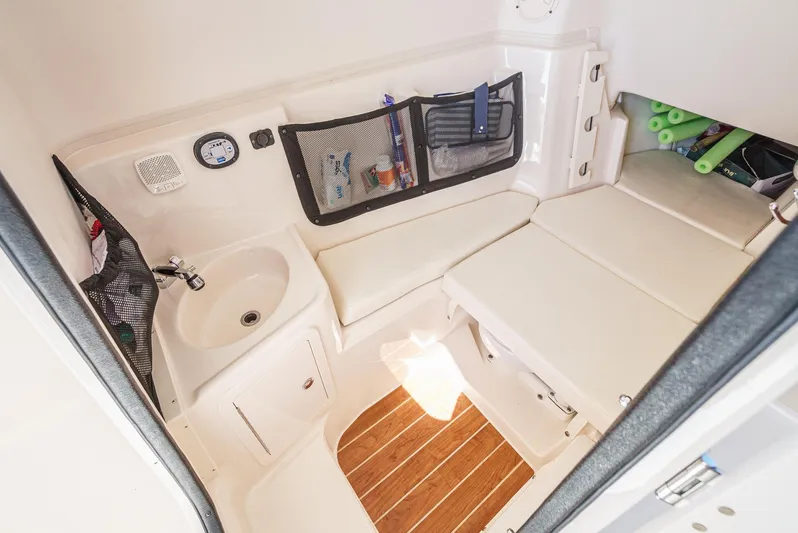  Yacht Photos Pics 2018 Grady-White Freedom 307 boat interior with seating, sink, and storage compartments.