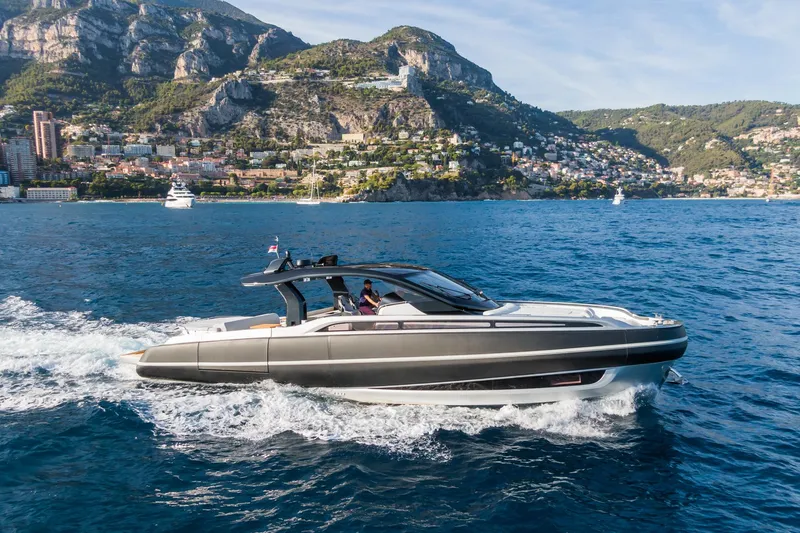 Ciao L Yacht Photos Pics 2022 SACS Rebel 55 yacht cruising near scenic coastal mountains.