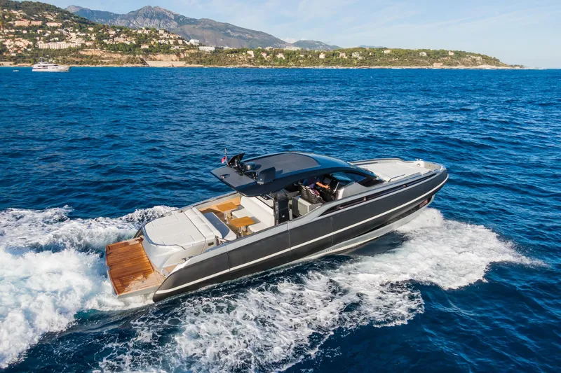 Ciao L Yacht Photos Pics 2022 SACS Rebel 55 yacht cruising on blue ocean near scenic coastline.