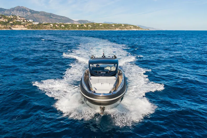 Ciao L Yacht Photos Pics 2022 SACS Rebel 55 yacht cruising on open sea with scenic coastline backdrop.