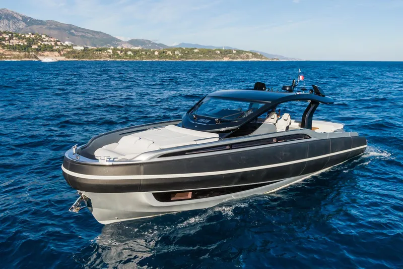 Ciao L Yacht Photos Pics 2022 SACS Rebel 55 yacht cruising on blue ocean near scenic coastline.