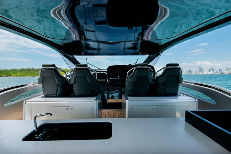 Ciao L Yacht Photos Pics Luxurious 2022 SACS Rebel 55 yacht interior with sleek seating and ocean view.