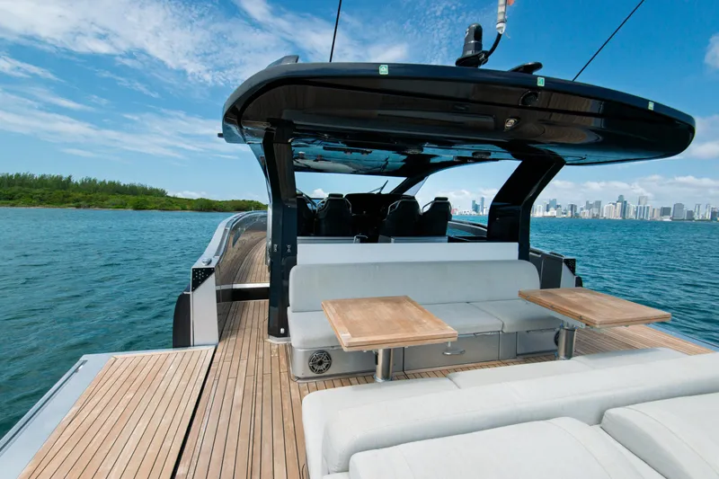 Ciao L Yacht Photos Pics 2022 SACS Rebel 55 yacht with sleek deck and city skyline in background.