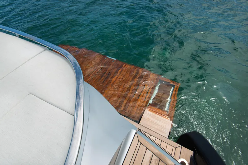 Ciao L Yacht Photos Pics Luxury SACS Rebel 55 yacht deck with wooden platform, 2022 model, on clear blue water.