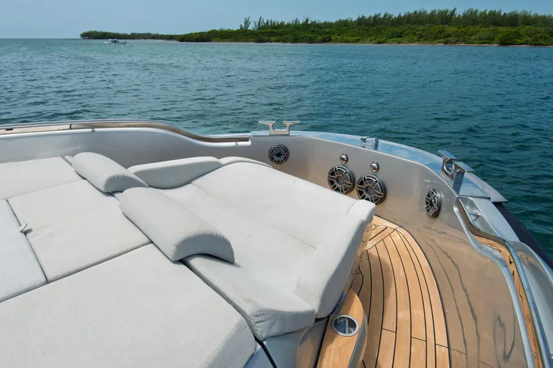 Ciao L Yacht Photos Pics Luxurious 2022 SACS Rebel 55 yacht with sunbathing deck on serene water.