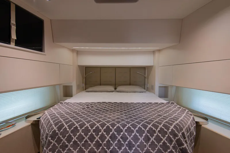 Ciao L Yacht Photos Pics Luxurious bedroom interior of 2022 SACS Rebel 55 yacht with modern design and cozy bedding.