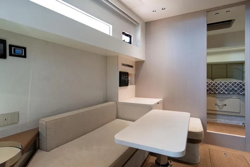 Ciao L Yacht Photos Pics Modern interior of 2022 SACS Rebel 55 yacht with sleek seating and table.