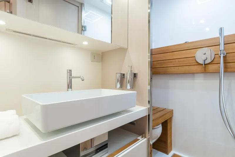 Ciao L Yacht Photos Pics Modern bathroom interior on 2022 SACS Rebel 55 yacht, featuring sleek sink and wooden accents.