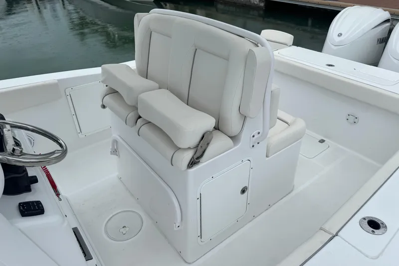  Yacht Photos Pics 2024 Sea Hunt Gamefish 27 Coffin Box boat interior with cushioned seating and steering wheel.