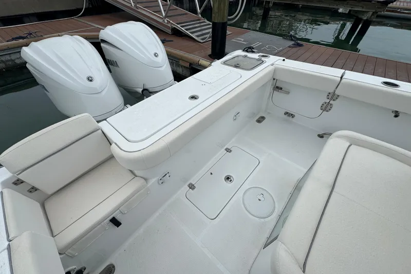  Yacht Photos Pics 2024 Sea Hunt Gamefish 27 Coffin Box boat interior with twin engines at dock.