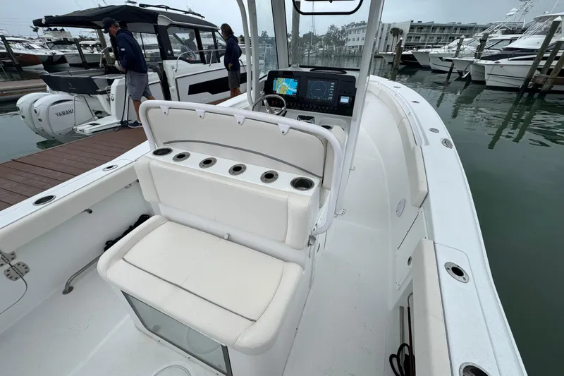  Yacht Photos Pics 2024 Sea Hunt Gamefish 27 Coffin Box boat interior at marina, featuring helm and seating.