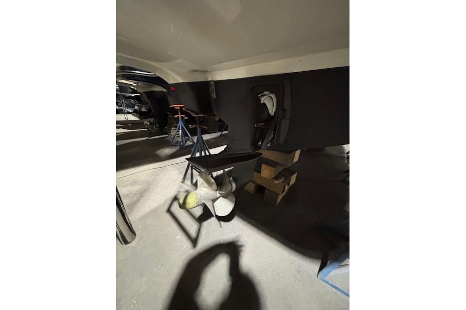 1998 Craig Craft Launch boat propeller and hull in a workshop setting.