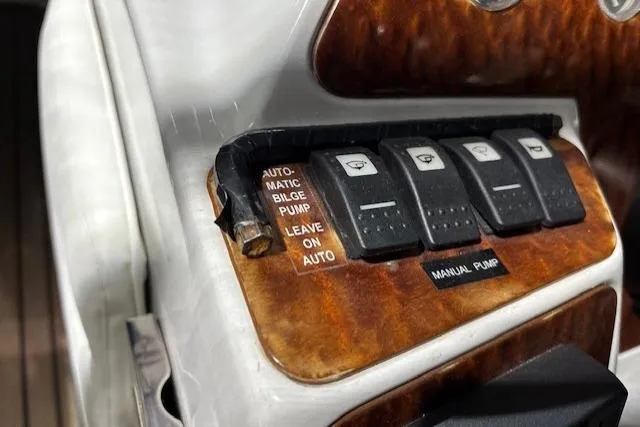 1998 Craig Craft Launch dashboard with automatic bilge pump switches and manual pump control.