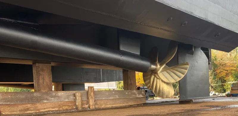 T1 Yacht Photos Pics Propeller of 2009 Custom Aluminum Landing Craft on dry dock, showcasing hull and support structure.
