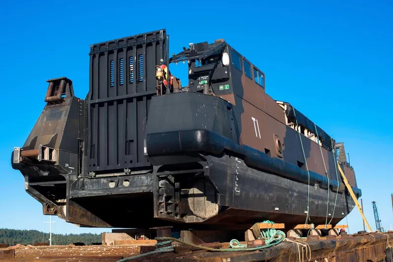 T1 Yacht Photos Pics Custom 2009 Aluminum Landing Craft on dry dock, viewed from the stern under clear blue sky.