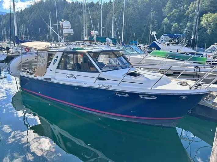 Denial Yacht Photos Pics 2012 Cutwater C-28 boat docked in a marina, surrounded by other vessels.