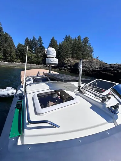 Denial Yacht Photos Pics 2012 Cutwater C-28 boat on water near forested shoreline.