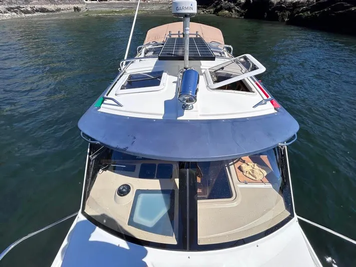 Denial Yacht Photos Pics 2012 Cutwater C-28 boat with open hatches, solar panel, and Garmin radar on calm water.