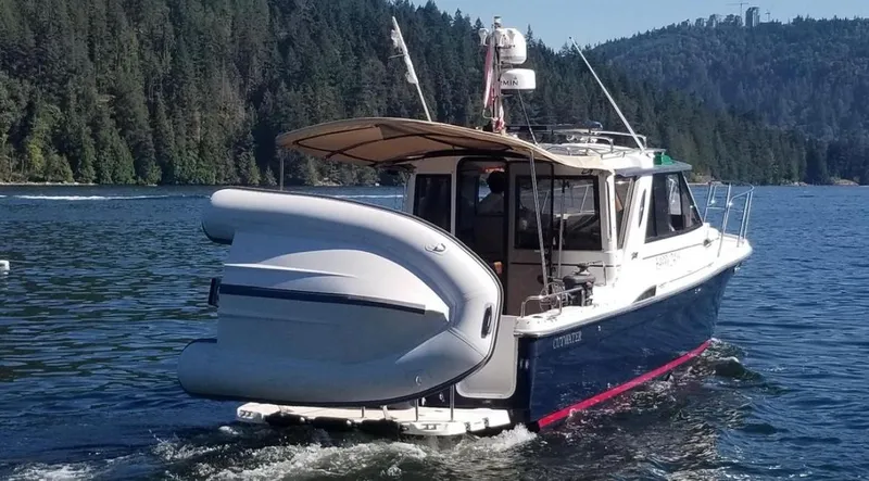 Denial Yacht Photos Pics 2012 Cutwater C-28 boat cruising on a scenic lake with forested hills in the background.